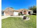 Charming single-story home with a well-manicured lawn and attached two-car garage at 6037 Hickory Grove Ln, Port Orange, FL 32128