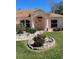 Charming home featuring a manicured front yard and inviting entryway with decorative columns at 6037 Hickory Grove Ln, Port Orange, FL 32128