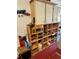 Garage cabinet with various storage items and a red carpet at 6037 Hickory Grove Ln, Port Orange, FL 32128