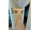 Long hallway with light-colored wood flooring adorned with picture frames on the walls at 6037 Hickory Grove Ln, Port Orange, FL 32128