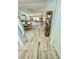 Hallway leading to dining area and kitchen, featuring neutral tile flooring at 6037 Hickory Grove Ln, Port Orange, FL 32128