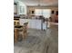 View of the kitchen with laminate floors and partial view of the living room at 6037 Hickory Grove Ln, Port Orange, FL 32128