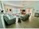 Bright living room with modern furnishings, wood flooring, and a view of the sliding glass door at 6037 Hickory Grove Ln, Port Orange, FL 32128