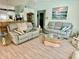 Comfortable living room with modern furnishings and a view of the kitchen bar at 6037 Hickory Grove Ln, Port Orange, FL 32128