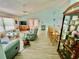 Open-concept living room featuring a kitchen bar and display cabinet at 6037 Hickory Grove Ln, Port Orange, FL 32128