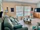Living room with sliding glass door views to the pool at 6037 Hickory Grove Ln, Port Orange, FL 32128