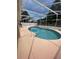 A large screened in pool with stairs at 6037 Hickory Grove Ln, Port Orange, FL 32128