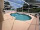 Inviting in-ground pool surrounded by ample patio space for lounging and relaxing at 6037 Hickory Grove Ln, Port Orange, FL 32128
