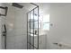 Modern bathroom featuring tiled shower with black hardware, vanity, and stylish fixtures at 604 Missouri Ave, St Cloud, FL 34769