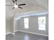 Bright bedroom with vaulted ceilings, ceiling fan, light floors, and two windows allowing natural light at 604 Missouri Ave, St Cloud, FL 34769