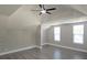 Bright bedroom with vaulted ceilings, a ceiling fan, and two windows providing natural light at 604 Missouri Ave, St Cloud, FL 34769