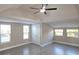 Vaulted bedroom with a ceiling fan, light floors, windows, and a double door closet at 604 Missouri Ave, St Cloud, FL 34769