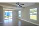 Bright living room featuring modern gray flooring, and sliding glass door to the backyard at 604 Missouri Ave, St Cloud, FL 34769