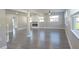 Bright, open living room featuring modern gray flooring, fireplace, and neutral paint at 604 Missouri Ave, St Cloud, FL 34769