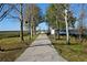 Scenic walking path lined with trees for enjoying nature and waterfront views at 604 Missouri Ave, St Cloud, FL 34769