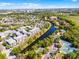 Stunning aerial view of a community with beautiful landscaping, a water feature, and tennis courts at 604 Mulberry Ave # 1201, Kissimmee, FL 34747