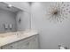 Bathroom featuring a granite vanity with double sinks and a large decorative mirror at 604 Mulberry Ave # 1201, Kissimmee, FL 34747