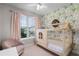 Charming bedroom with a wooden house-style bed frame, floral wallpaper, and sunlit window at 604 Mulberry Ave # 1201, Kissimmee, FL 34747