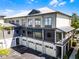 Exterior of a multi-unit building with garage doors, balconies, and neutral color scheme at 604 Mulberry Ave # 1201, Kissimmee, FL 34747