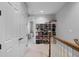 Hallway with a white shelving unit filled with board games and an open doorway at 604 Mulberry Ave # 1201, Kissimmee, FL 34747