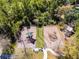 Aerial view of a playground with mulch groundcover surrounded by many trees and bushes at 604 Mulberry Ave # 1201, Kissimmee, FL 34747