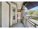 A covered porch featuring a railing, siding, an exit sign, and a door with a window at 604 Mulberry Ave # 1201, Kissimmee, FL 34747