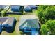 Aerial view of a well-maintained blue house with a green roof in a residential neighborhood at 608 Robin Ln, Kissimmee, FL 34759