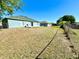 Fenced backyard with a patio and grassy area at 608 Robin Ln, Kissimmee, FL 34759