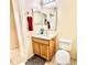 Bathroom with a wood vanity, single mirror, and a toilet at 608 Robin Ln, Kissimmee, FL 34759