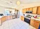 Spacious kitchen featuring modern stainless steel appliances, wood cabinets, and tile flooring at 608 Robin Ln, Kissimmee, FL 34759