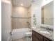 Full bathroom featuring a shower-tub combo, granite counters, and tiled floors at 6611 Lullaby Ln, Mascotte, FL 34753