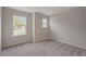 A serene bedroom features plush carpeting and natural light streaming through its bright windows at 6611 Lullaby Ln, Mascotte, FL 34753