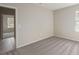 Well-lit bedroom featuring neutral walls, carpeting, and a view of an adjoining hallway at 6611 Lullaby Ln, Mascotte, FL 34753