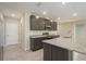 Bright kitchen with gray cabinets, stainless steel appliances, and granite countertops at 6611 Lullaby Ln, Mascotte, FL 34753