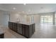 Kitchen with gray cabinets, granite countertops, a large island, and stainless steel appliances at 6611 Lullaby Ln, Mascotte, FL 34753