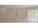 Large living room featuring recessed lighting, French doors, and sliding glass doors to backyard at 6611 Lullaby Ln, Mascotte, FL 34753