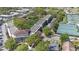 Aerial view highlights the community buildings, tennis courts, parking and surrounding residential area at 700 Melrose Ave # L-23, Winter Park, FL 32789