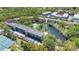 Aerial view showcases the community buildings, pool, tennis courts, parking and surrounding greenery at 700 Melrose Ave # L-23, Winter Park, FL 32789