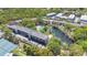 Aerial view showcases the community buildings, pool, tennis courts, parking and surrounding greenery at 700 Melrose Ave # L-23, Winter Park, FL 32789