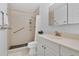 Bathroom featuring accessible shower with grab bars, and neutral toned cabinets at 700 Melrose Ave # L-23, Winter Park, FL 32789