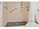 Modern bathroom with tiled shower, built-in shelving, and safety grab bars at 700 Melrose Ave # L-23, Winter Park, FL 32789