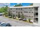 The exterior showcases the building architecture with large windows, balconies, and manicured landscaping at 700 Melrose Ave # L-23, Winter Park, FL 32789