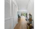 Hallway with ample closet space and a view into the bright and airy living area at 700 Melrose Ave # L-23, Winter Park, FL 32789