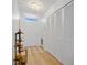 Bright hallway featuring a coat closet, natural light, and wood floors, creating an inviting entrance at 700 Melrose Ave # L-23, Winter Park, FL 32789