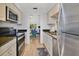 Bright kitchen featuring stainless steel appliances and view into adjacent dining area at 700 Melrose Ave # L-23, Winter Park, FL 32789