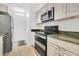 Kitchen showcasing modern stainless steel appliances, cabinets, and stone countertops at 700 Melrose Ave # L-23, Winter Park, FL 32789