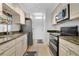 Bright kitchen features stainless steel appliances, including a refrigerator, oven, and undermount sink at 700 Melrose Ave # L-23, Winter Park, FL 32789