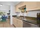 Kitchen with neutral cabinets, stone countertops, and an open view to the living room at 700 Melrose Ave # L-23, Winter Park, FL 32789