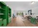 Bright living room with hardwood floors, colorful shelving, and an open floor plan perfect for entertaining at 700 Melrose Ave # L-23, Winter Park, FL 32789