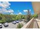 Exterior view from condo balcony showcasing parking area and green, wooded surroundings at 700 Melrose Ave # L-23, Winter Park, FL 32789